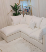 a white couch with pillows in a room